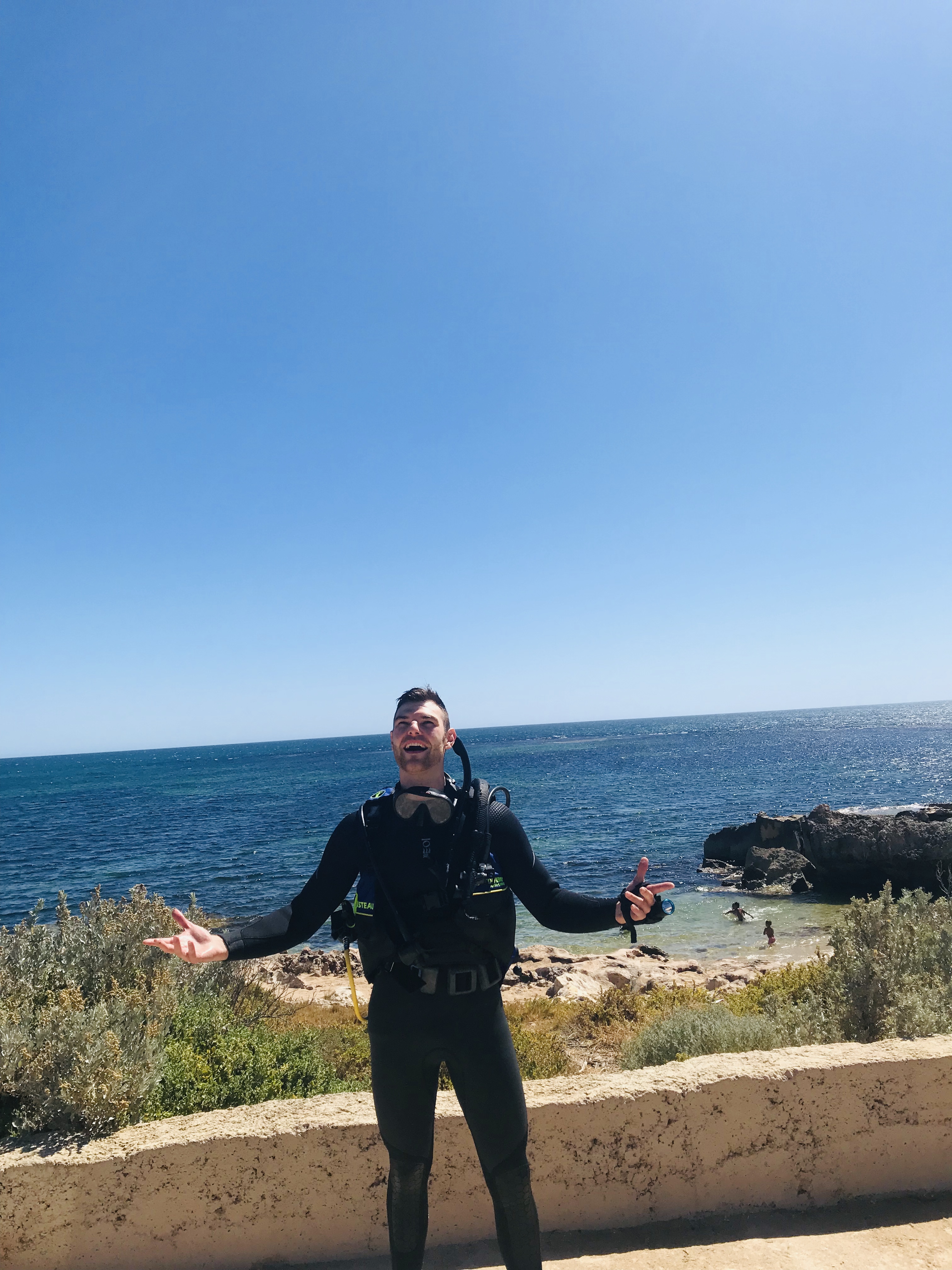 Bryce Huston in diving gear near the ocean
