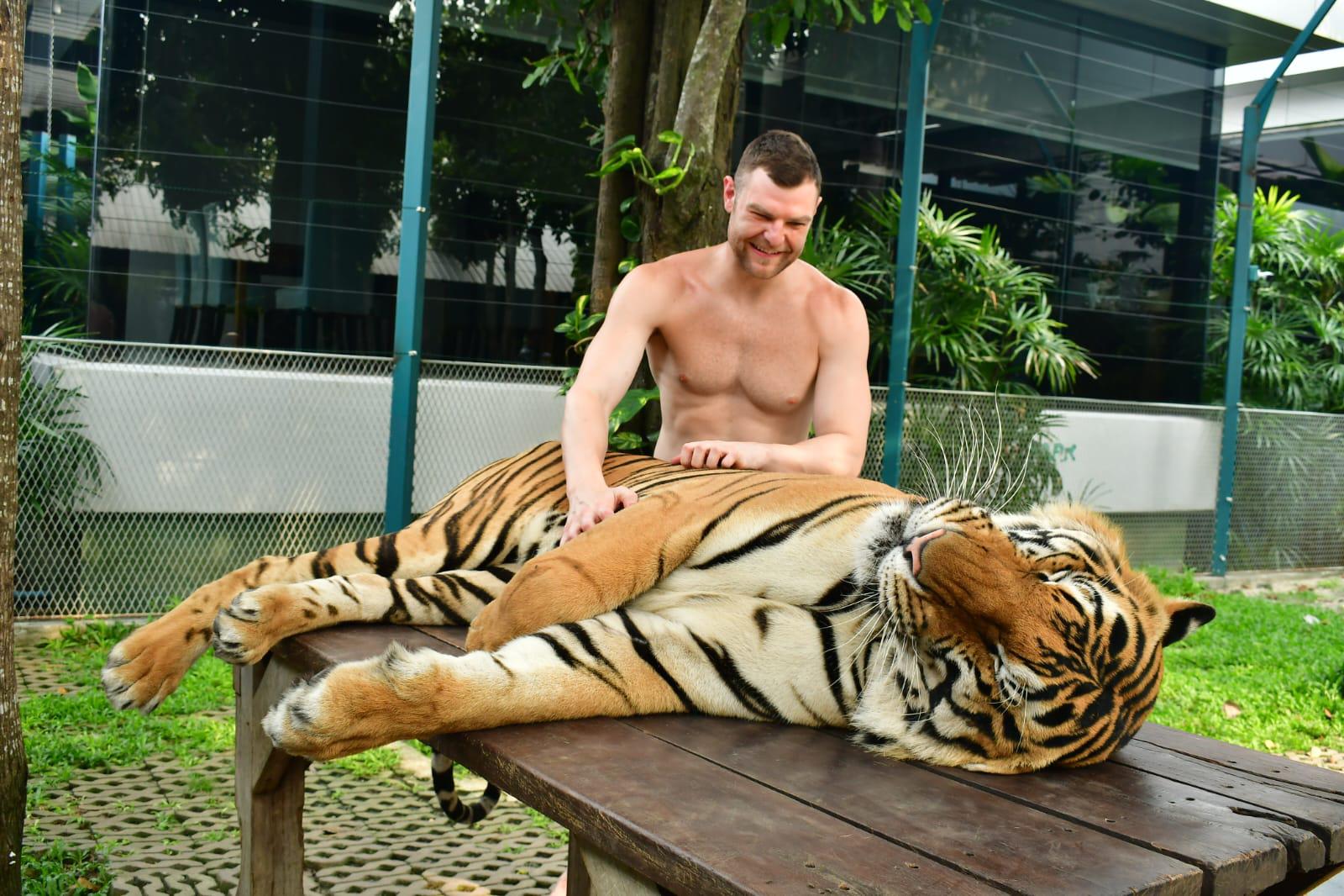 Bryce Huston beside a tiger