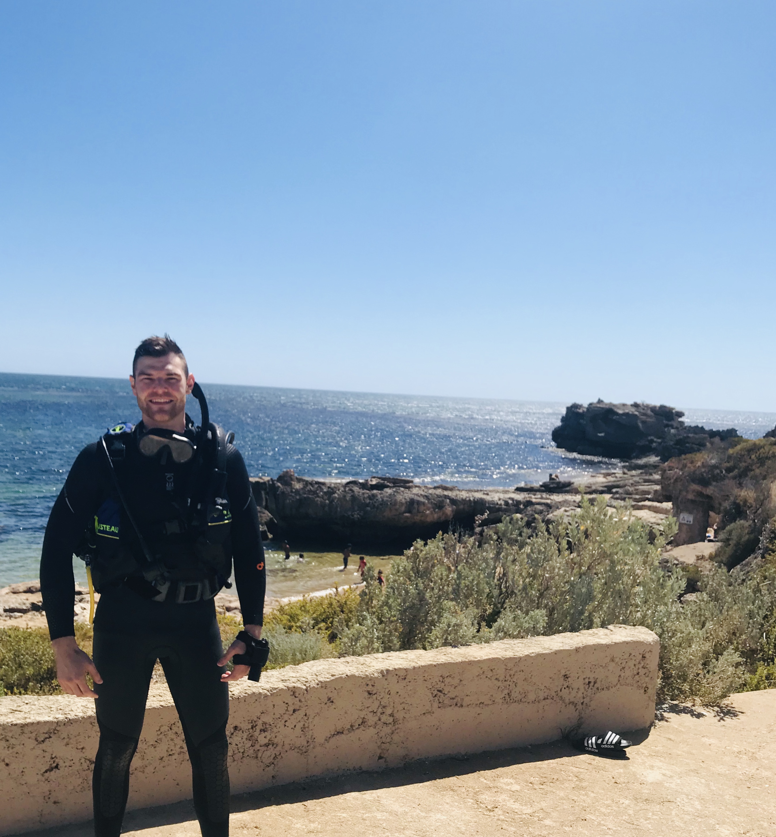 Bryce Huston in diving gear by the ocean